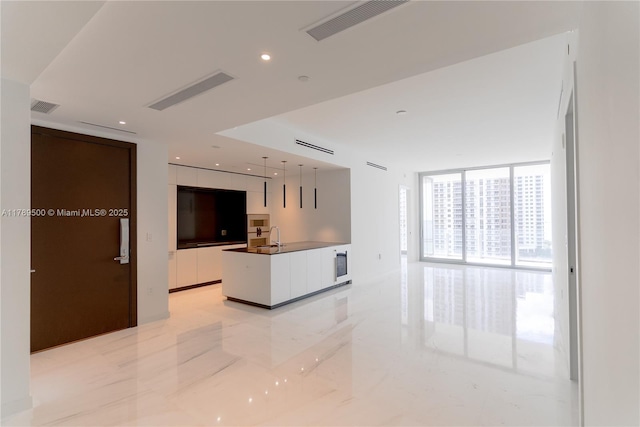 kitchen with visible vents, modern cabinets, recessed lighting, and white cabinets