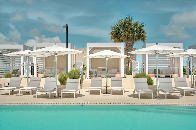 rear view of property with a community pool