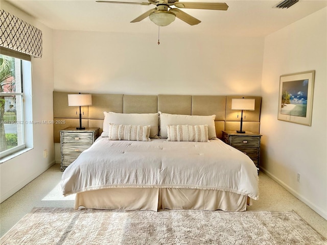 carpeted bedroom with visible vents, a ceiling fan, and baseboards
