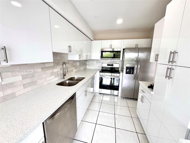 5900 SW 127th Ave Unit 3410, Miami, FL 33183 - kitchen featuring white cabinets, stainless steel appliances, a sink, light tile patterned flooring, and backsplash