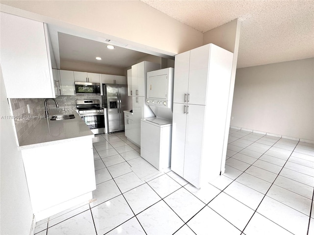 5900 SW 127th Ave Unit 3410, Miami, FL 33183 - kitchen featuring stacked washer / drying machine, white cabinets, a sink, and appliances with stainless steel finishes