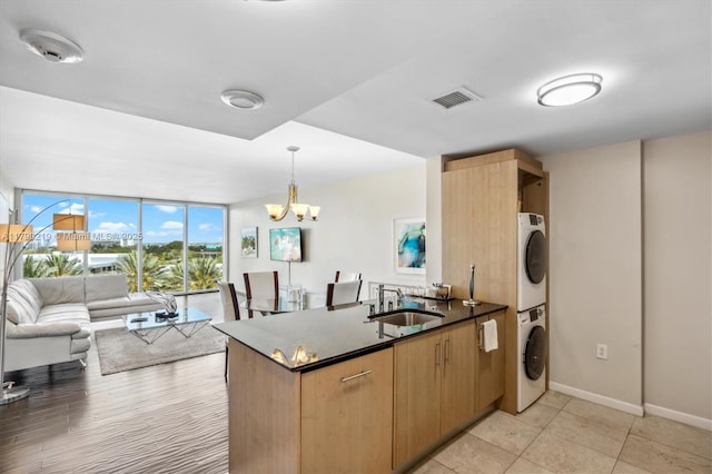 10275 Collins Ave Unit 529, Bal Harbour, FL 33154 - kitchen with a sink, expansive windows, visible vents, stacked washer / dryer, and open floor plan