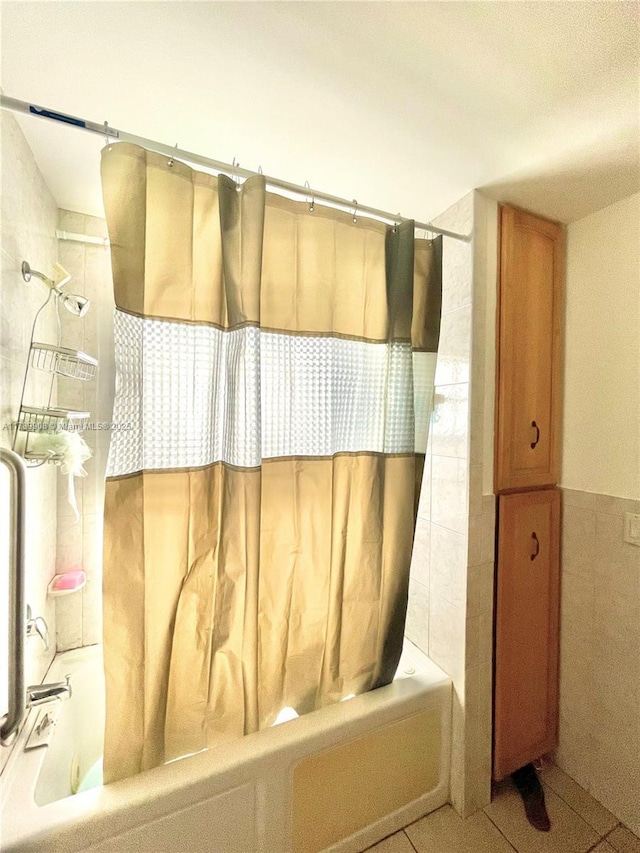 full bathroom with tile walls and shower / bath combo