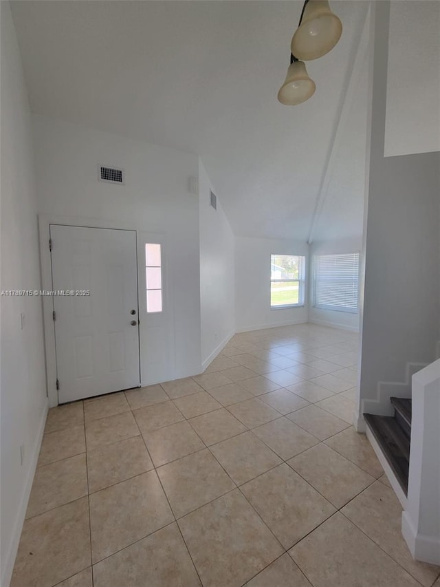 foyer entrance with light tile patterned flooring, visible vents, and baseboards