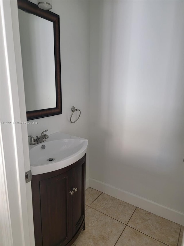 bathroom featuring vanity, tile patterned flooring, and baseboards