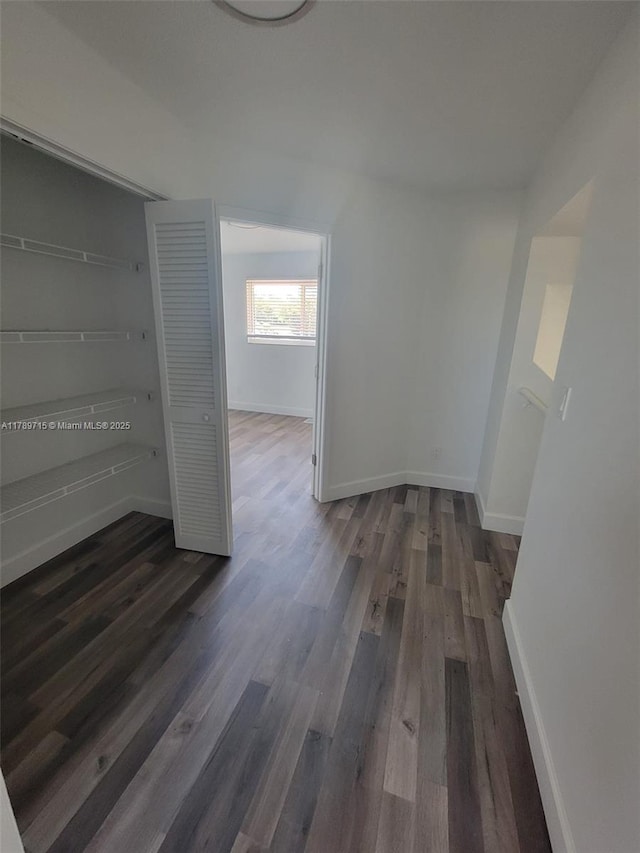 interior space with dark wood finished floors and baseboards