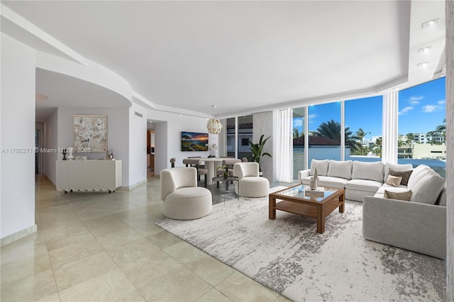 300 S Pointe Dr Unit 405, Miami Beach, FL 33139 - living room featuring baseboards, tile patterned flooring, and floor to ceiling windows