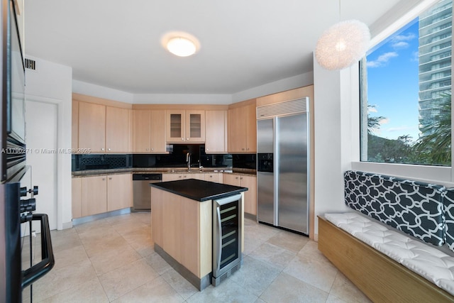 300 S Pointe Dr Unit 405, Miami Beach, FL 33139 - kitchen featuring wine cooler, appliances with stainless steel finishes, decorative backsplash, and light brown cabinets
