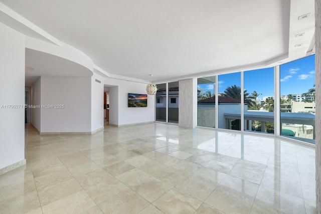 300 S Pointe Dr Unit 405, Miami Beach, FL 33139 - empty room with baseboards, floor to ceiling windows, and light tile patterned flooring