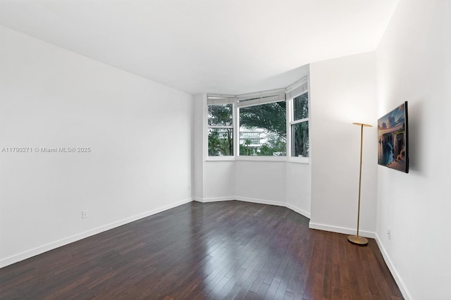 300 S Pointe Dr Unit 405, Miami Beach, FL 33139 - spare room featuring baseboards and dark wood-style flooring