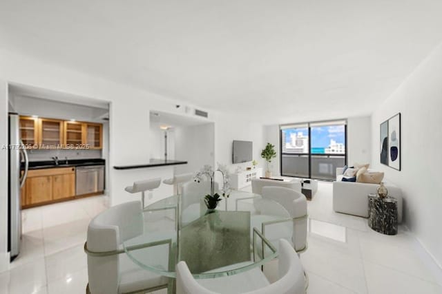 1775 Washington Ave Unit 11C, Miami Beach, FL 33139 - dining room with light tile patterned flooring