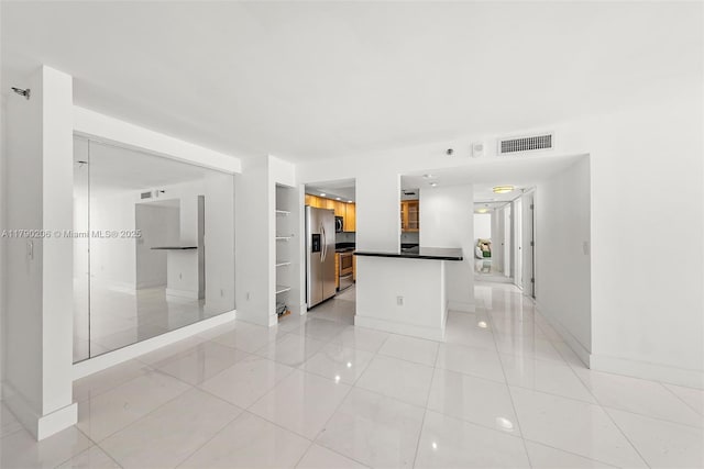 1775 Washington Ave Unit 11C, Miami Beach, FL 33139 - unfurnished living room with light tile patterned floors and baseboards