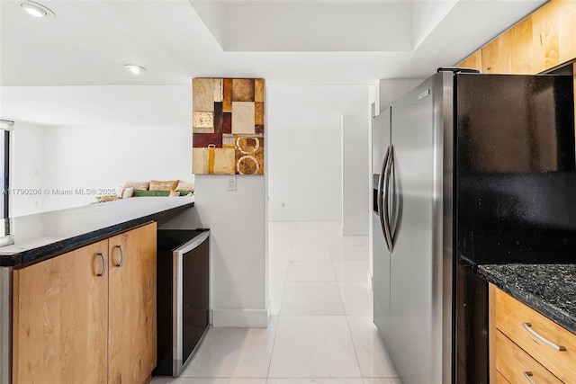1775 Washington Ave Unit 11C, Miami Beach, FL 33139 - kitchen featuring stainless steel refrigerator with ice dispenser, light tile patterned flooring, a peninsula, wine cooler, and dark stone counters