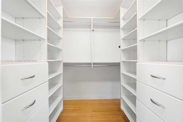 1775 Washington Ave Unit 11C, Miami Beach, FL 33139 - walk in closet featuring wood finished floors