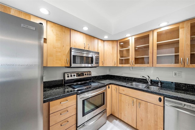 1775 Washington Ave Unit 11C, Miami Beach, FL 33139 - kitchen with appliances with stainless steel finishes, a sink, dark stone counters, recessed lighting, and light brown cabinets