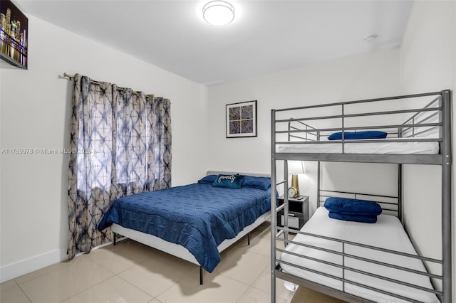 bedroom featuring tile patterned floors and baseboards