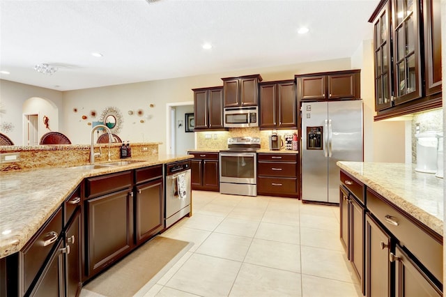 20951 SW 134th Ave, Miami, FL 33177 - kitchen with appliances with stainless steel finishes, a sink, backsplash, light tile patterned flooring, and light stone countertops