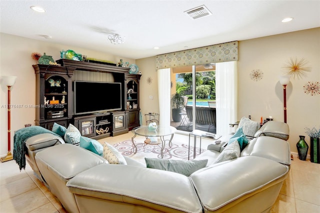 tiled living room featuring baseboards, visible vents, and recessed lighting