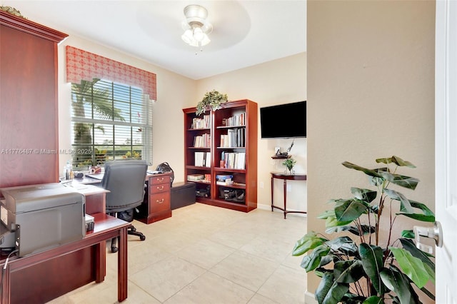 office space with a ceiling fan and light tile patterned floors