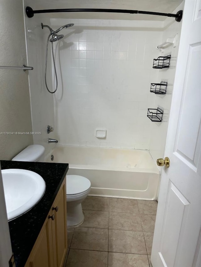 bathroom with tile patterned flooring, toilet, vanity, and shower / washtub combination