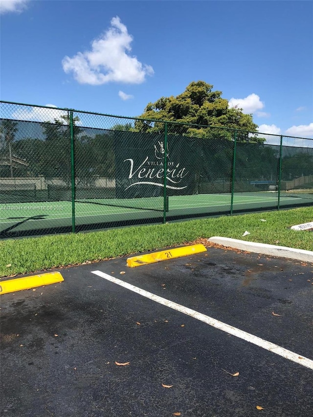 uncovered parking lot featuring fence