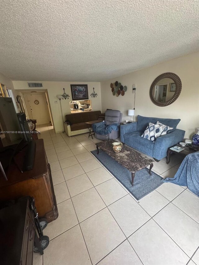 9360 Fontainebleau Blvd Unit 208, Miami, FL 33172 - living area with a textured ceiling and light tile patterned floors