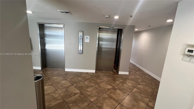 16570 NE 26th Ave Unit 4A, North Miami Beach, FL 33160 - corridor featuring elevator, recessed lighting, dark tile patterned flooring, and baseboards