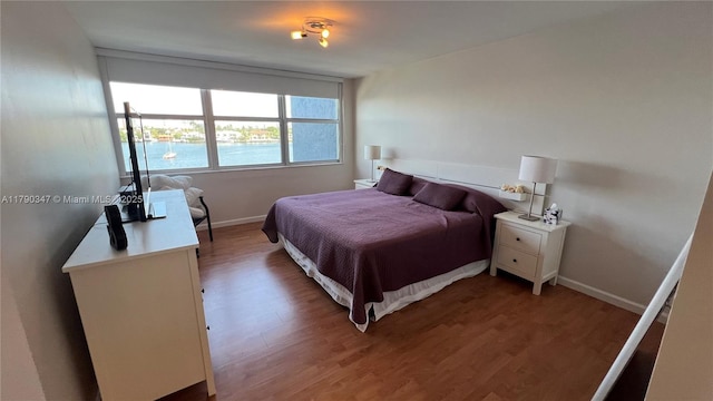 16570 NE 26th Ave Unit 4A, North Miami Beach, FL 33160 - bedroom with light wood-type flooring and baseboards