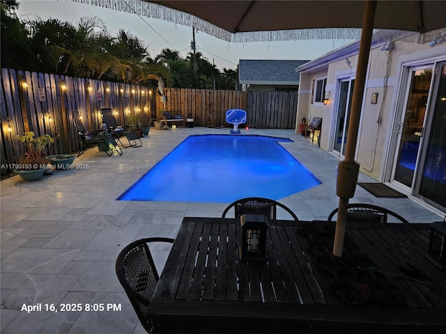 view of swimming pool featuring a patio, a fenced in pool, and a fenced backyard