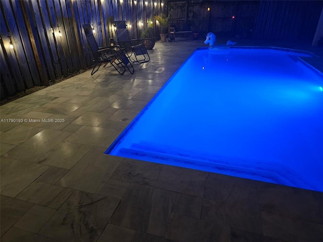 view of swimming pool with a patio, a fenced backyard, and a fenced in pool