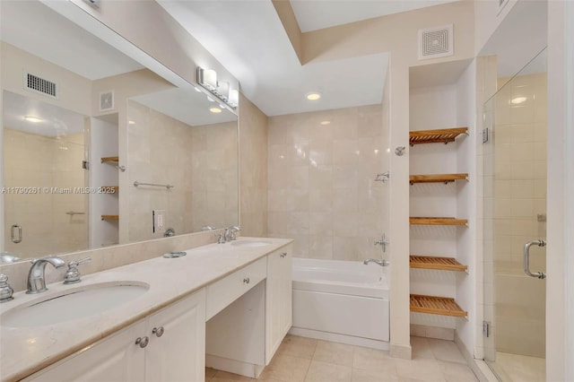 bathroom with a shower stall, a sink, and visible vents