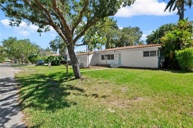 10635 NE 11th Ct, Miami Shores, FL 33138 - exterior space featuring stucco siding and a front yard