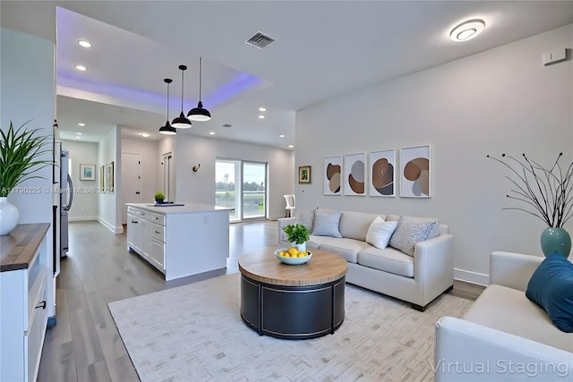 5224 Columbus Blvd, Sebring, FL 33872 - living area with light wood-type flooring, recessed lighting, and baseboards
