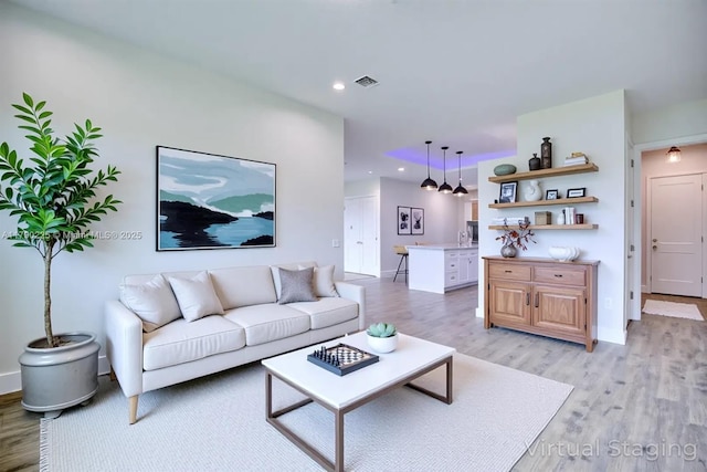 5224 Columbus Blvd, Sebring, FL 33872 - living area featuring light wood-style flooring, recessed lighting, and baseboards