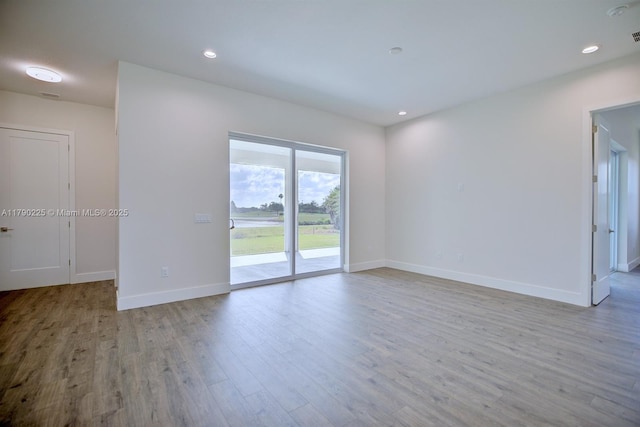 5224 Columbus Blvd, Sebring, FL 33872 - unfurnished room with baseboards, wood finished floors, and recessed lighting