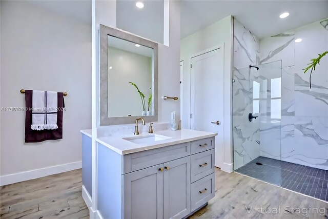 5224 Columbus Blvd, Sebring, FL 33872 - bathroom featuring a marble finish shower, vanity, wood finished floors, and recessed lighting