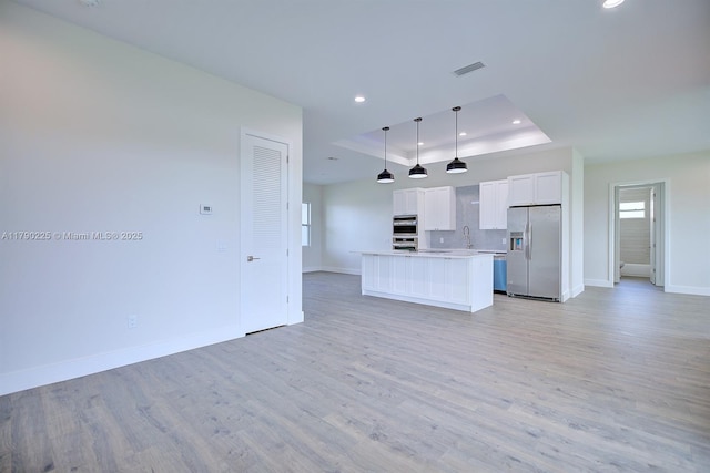 5224 Columbus Blvd, Sebring, FL 33872 - kitchen featuring open floor plan, a raised ceiling, baseboards, appliances with stainless steel finishes, and visible vents