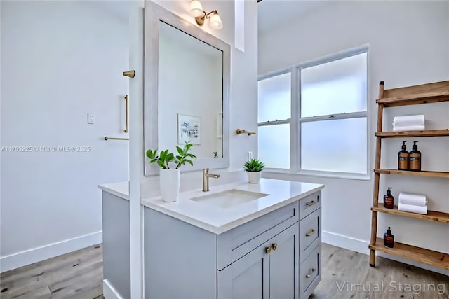 5224 Columbus Blvd, Sebring, FL 33872 - bathroom featuring vanity, wood finished floors, and baseboards