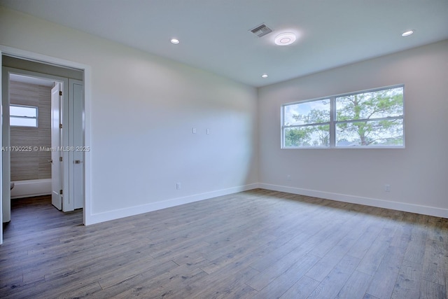 5224 Columbus Blvd, Sebring, FL 33872 - spare room featuring recessed lighting, wood finished floors, visible vents, and baseboards