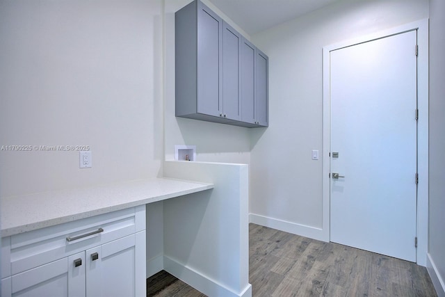5224 Columbus Blvd, Sebring, FL 33872 - clothes washing area featuring cabinet space, light wood-style flooring, hookup for a washing machine, and baseboards