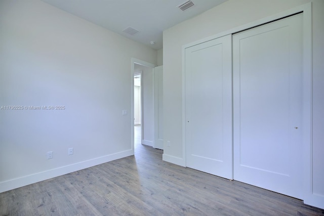 5224 Columbus Blvd, Sebring, FL 33872 - unfurnished bedroom featuring baseboards, wood finished floors, and visible vents