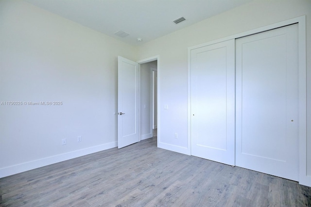 5224 Columbus Blvd, Sebring, FL 33872 - unfurnished bedroom featuring wood finished floors, baseboards, and a closet