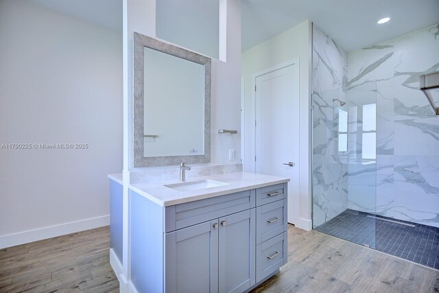 5224 Columbus Blvd, Sebring, FL 33872 - full bathroom with a marble finish shower, wood finished floors, vanity, recessed lighting, and baseboards