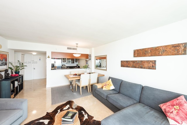 living room featuring tile patterned flooring and visible vents