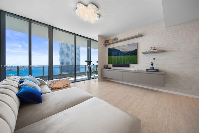 1000 Brickell Plz Unit Ph5603, Miami, FL 33131 - living room featuring wood finished floors, expansive windows, and a water view