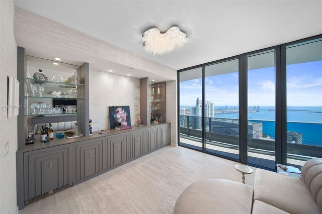 1000 Brickell Plz Unit Ph5603, Miami, FL 33131 - living area featuring a water view, expansive windows, and wood finished floors