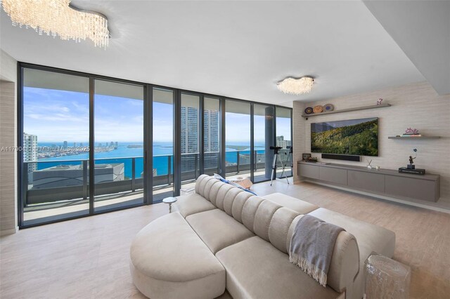 1000 Brickell Plz Unit Ph5603, Miami, FL 33131 - living room with a wall of windows, wood finished floors, and a chandelier