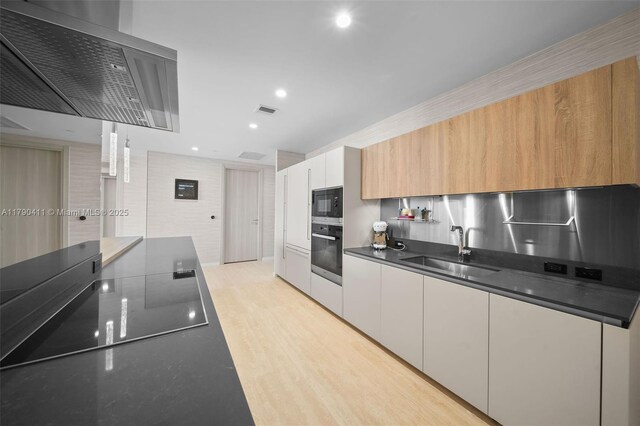 1000 Brickell Plz Unit Ph5603, Miami, FL 33131 - kitchen with black appliances, a sink, dark countertops, modern cabinets, and recessed lighting
