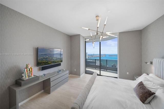 1000 Brickell Plz Unit Ph5603, Miami, FL 33131 - bedroom with a wall of windows, wallpapered walls, access to outside, and a chandelier