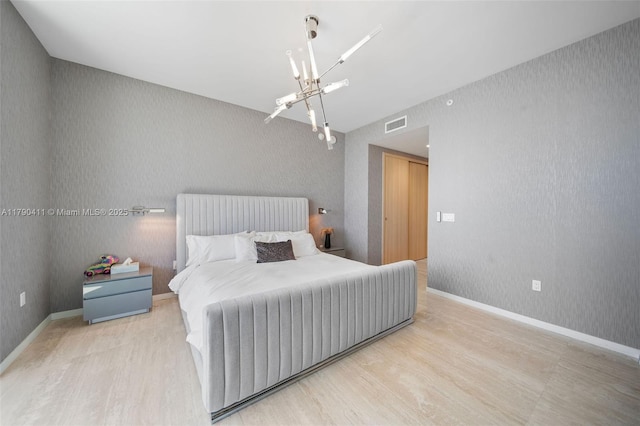 1000 Brickell Plz Unit Ph5603, Miami, FL 33131 - bedroom with a chandelier, wood finished floors, and baseboards
